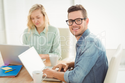 Portrait of smiling young man wearing eyeglasses with woman