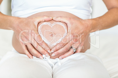 Midsection of woman with heart shape