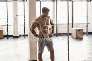 Serious muscular shirtless man posing