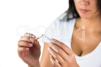 Happy woman breaking a cigarette in two