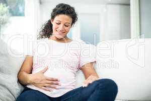 Pregnant woman looking at belly