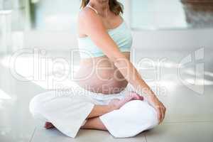 Low section of woman practicing yoga