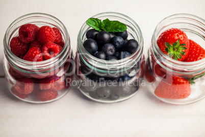 Glass jars of fresh berries