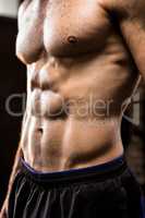 Midsection of man showing abs