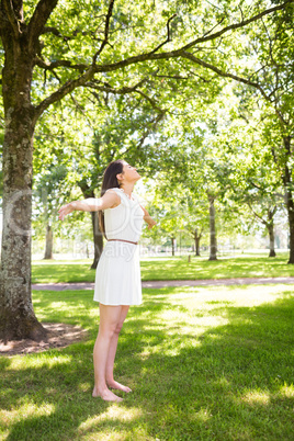 Pretty woman standing on grass in park