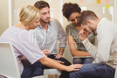 Business people consoling distressed businessman