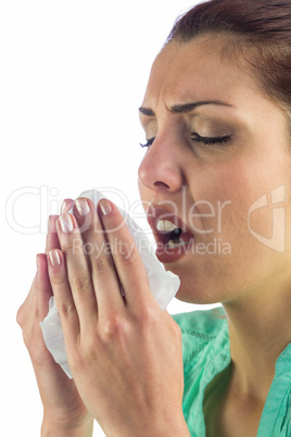 Sneezing woman holding tissue with mouth open