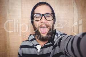 Portrait of happy hipster sticking out tongue