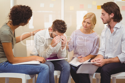 Stressed worker with her colleagues