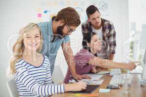 Portrait of smiling woman using digital tablet