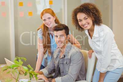 Smiling business people with laptop