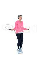 Full length of mature woman exercising with jump rope