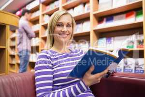 Portrait of young woman reading book