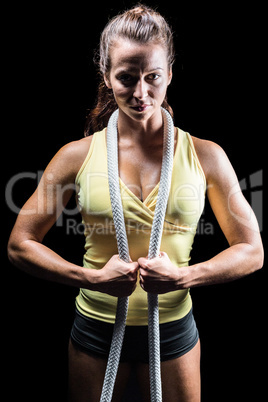 Portrait of healthy woman holding rope around neck