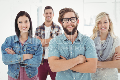 Portrait of smiling business professionals with arms crossed