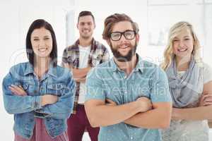 Portrait of smiling business professionals with arms crossed