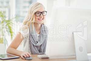 Smiling woman using computer