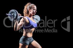 Side view of woman exercising with crossfit