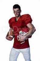 Rugby player holding ball and helmet