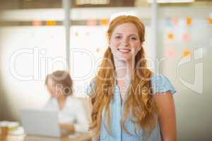 Smiling businesswoman standing in office