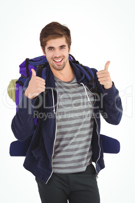 Portrait of happy man with backpack showing thumbs up
