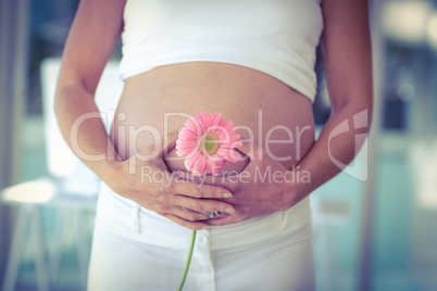 Midsection of woman holding flower