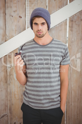 Portrait of man holding smoking pipe