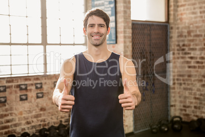 Portrait of a man showing thumbs up