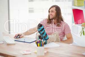Hipster with legs on desk