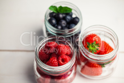 Glass jars of fresh berries