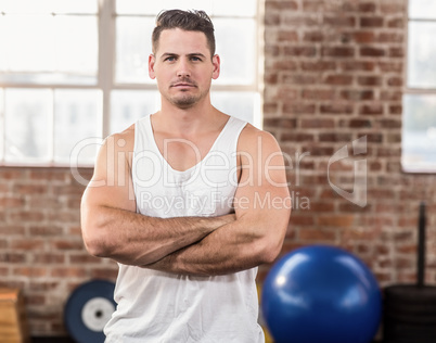 Portrait of muscular man with arms crossed