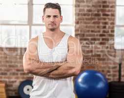 Portrait of muscular man with arms crossed