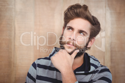 Close-up of thoughtful hipster with hand on chin