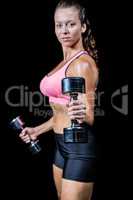 Portrait side view of woman exercising with dumbbells