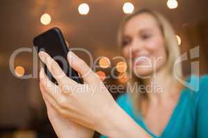 Happy young woman with mobile phone