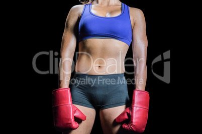Midsection of female boxer with gloves