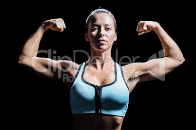 Thoughtful athlete flexing muscles