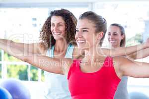 Cheerful women with arms outstretched