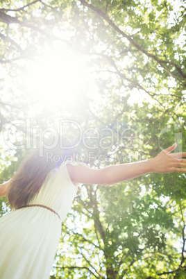 Low angle view of woman against bright sunlight