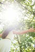 Low angle view of woman against bright sunlight