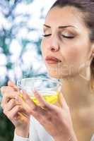 Beautiful woman smelling herbal tea