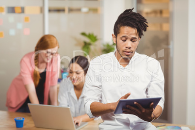 Businessman using digital tablet in office