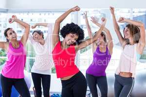 women exercising with arms raised