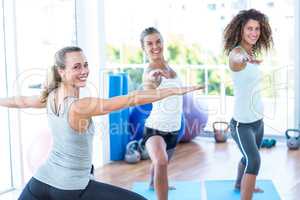 Portrait of women doing warrior II pose