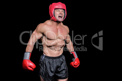 Angry boxer against black background