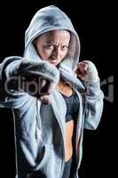Portrait of female fighter in hood with fighting stance