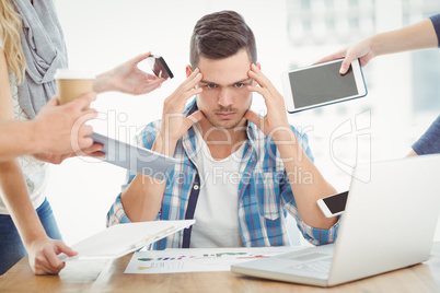 Tensed businessman with head in hand
