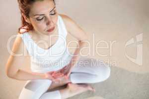 Overhead view of woman in yoga pose with eyes closed