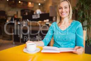 Portrait of young woman holding book