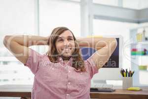 Happy man relaxing at computer desk